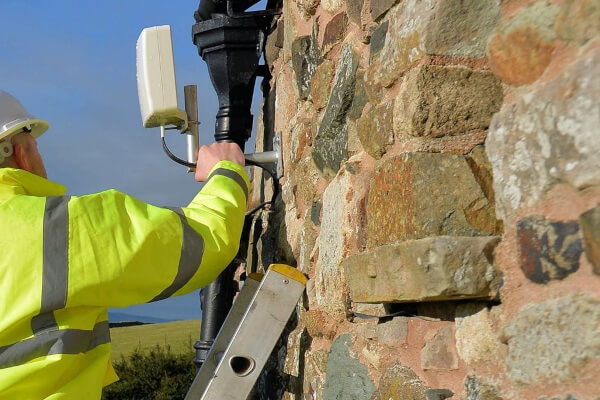 An engineer installing an antenna