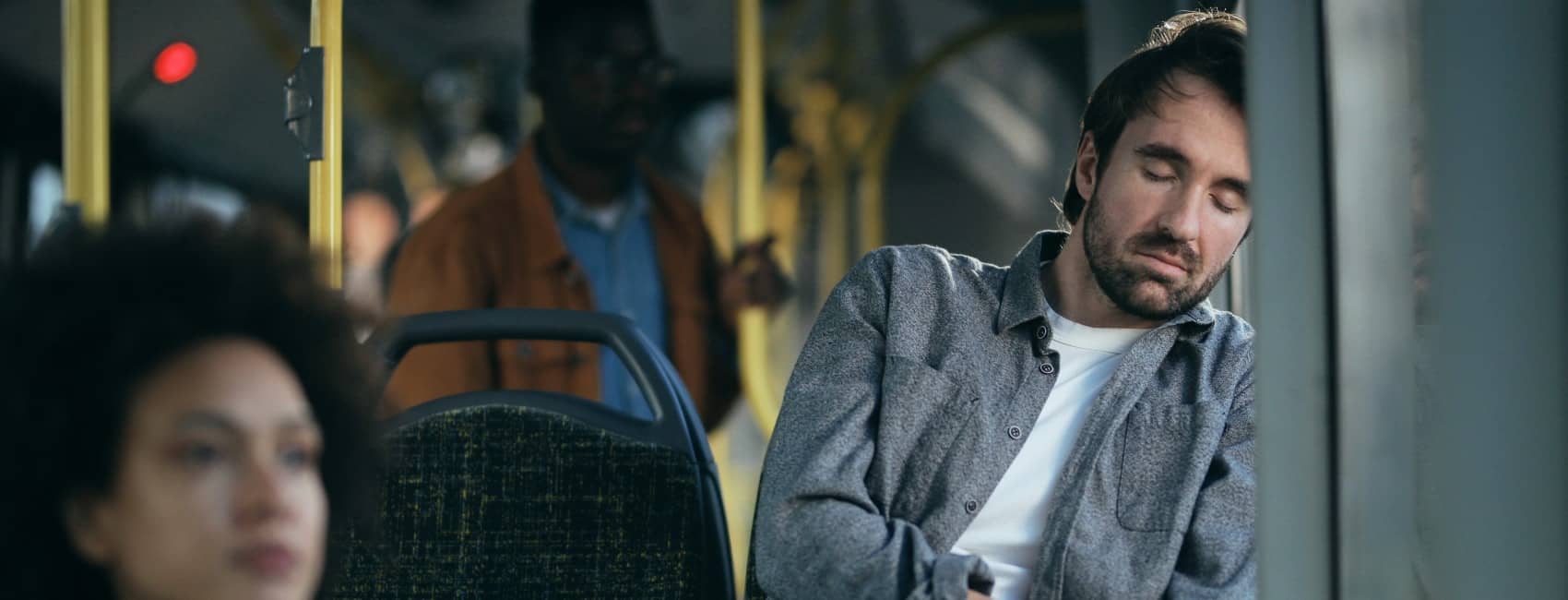 A person sleeping on a bus
